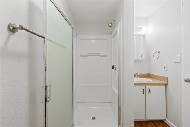 a bathroom with a shower and a sink