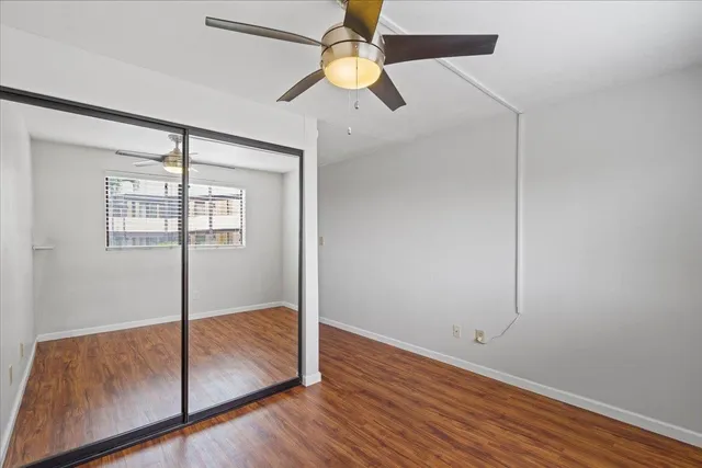 a bedroom with a bed and a chandelier fan