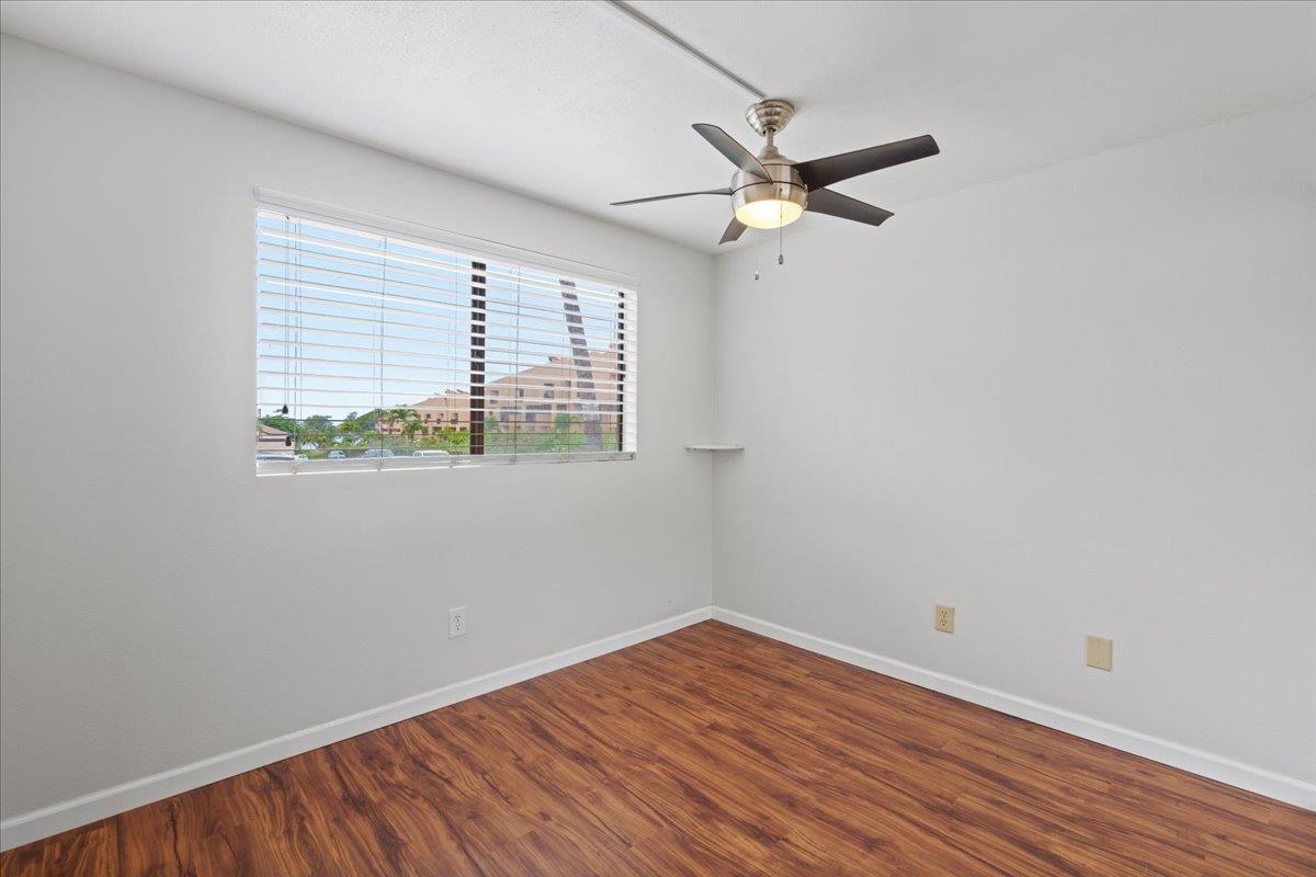 2747 South Kihei Road, Unit A107 Kihei, HI 96753 - Photo 36 of 46 an empty room with wooden floor fan and windows