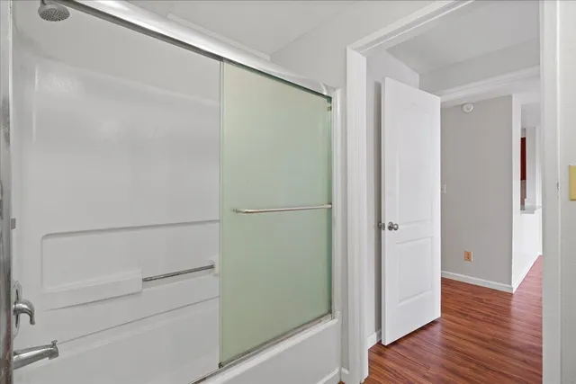 a view of walk in closet with wooden floor