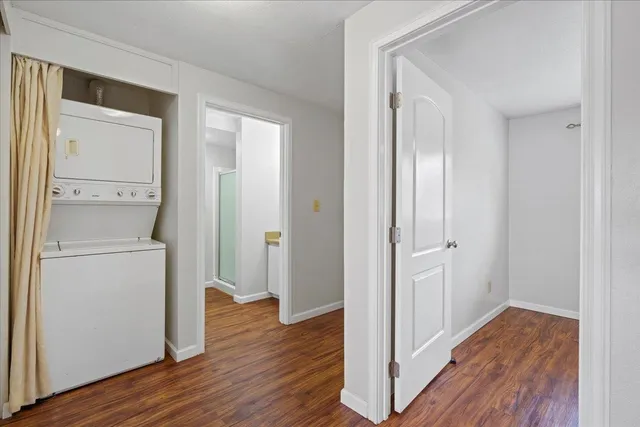 a view of a hallway with wooden floor