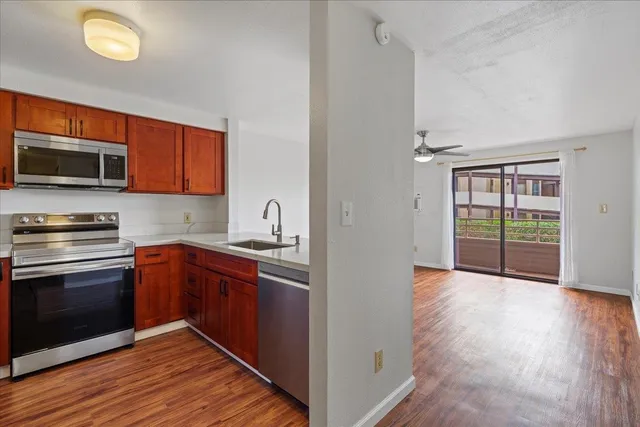 a kitchen with stainless steel appliances granite countertop a stove and a sink