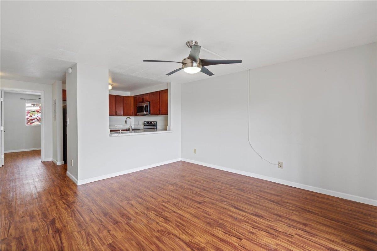 2747 South Kihei Road, Unit A107 Kihei, HI 96753 - Photo 10 of 46 a view of a room with wooden floor and ceiling fan