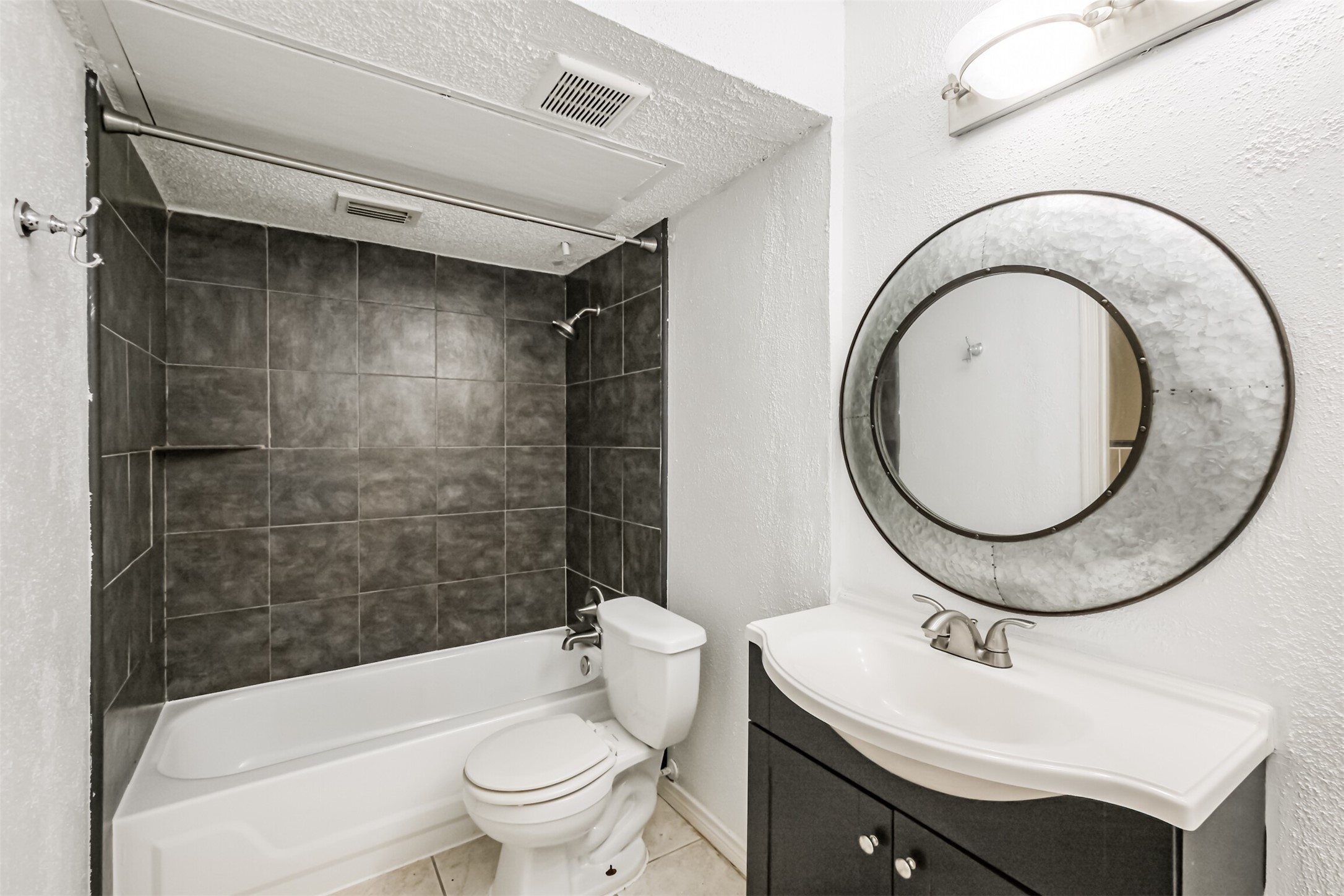 3100 Jeanetta Street, Unit 1305 Houston, TX 77063 - Photo 15 of 21 a bathroom with a sink a toilet and a mirror