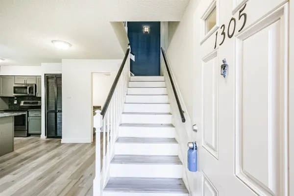 a view of entryway and hall with wooden floor