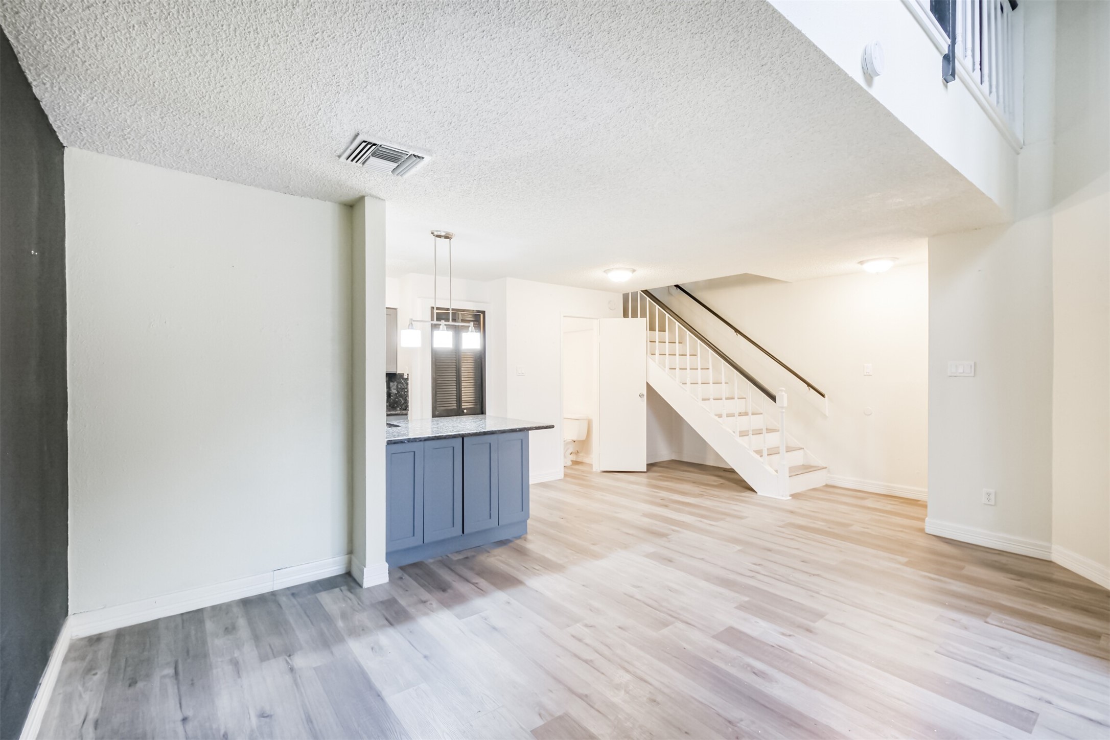 3100 Jeanetta Street, Unit 1305 Houston, TX 77063 - Photo 4 of 21 a view of an empty room with wooden floor and stairs