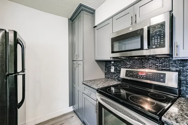a stove top oven sitting inside of a kitchen