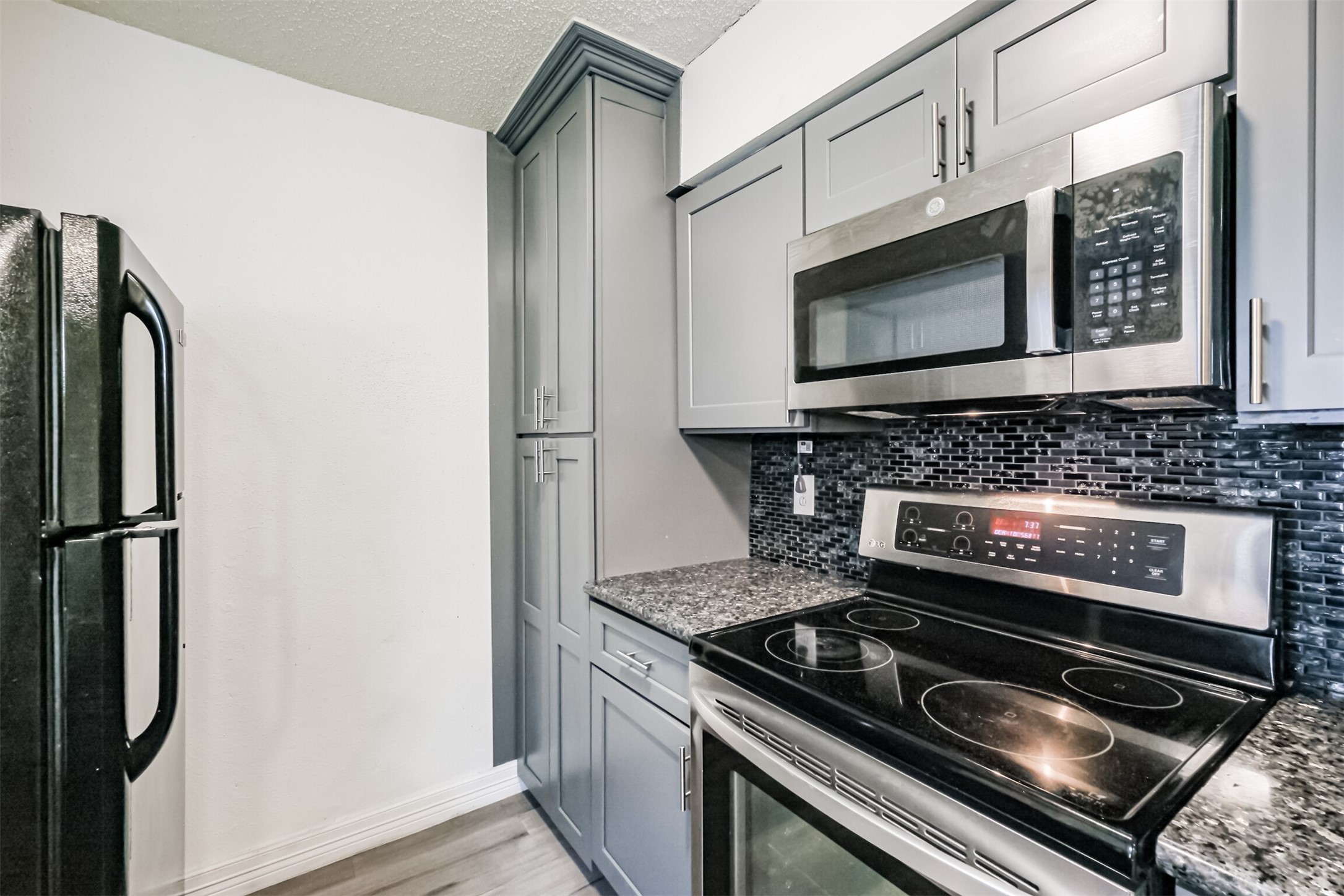 3100 Jeanetta Street, Unit 1305 Houston, TX 77063 - Photo 6 of 21 a stove top oven sitting inside of a kitchen