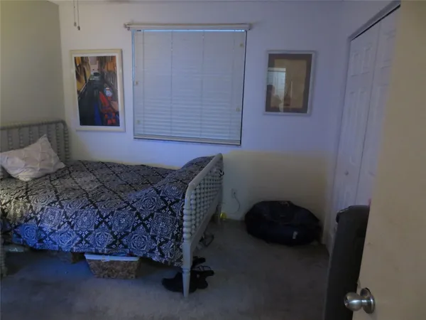 a bed sitting in a room next to a window