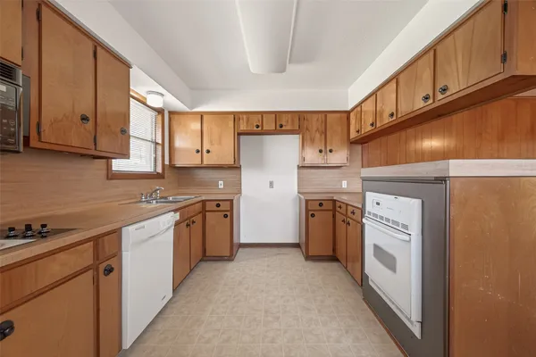 a kitchen with a white cabinets and white appliances