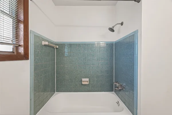 a bathroom with a shower and a bathtub