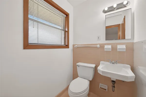 a white toilet sitting next to a bathroom sink