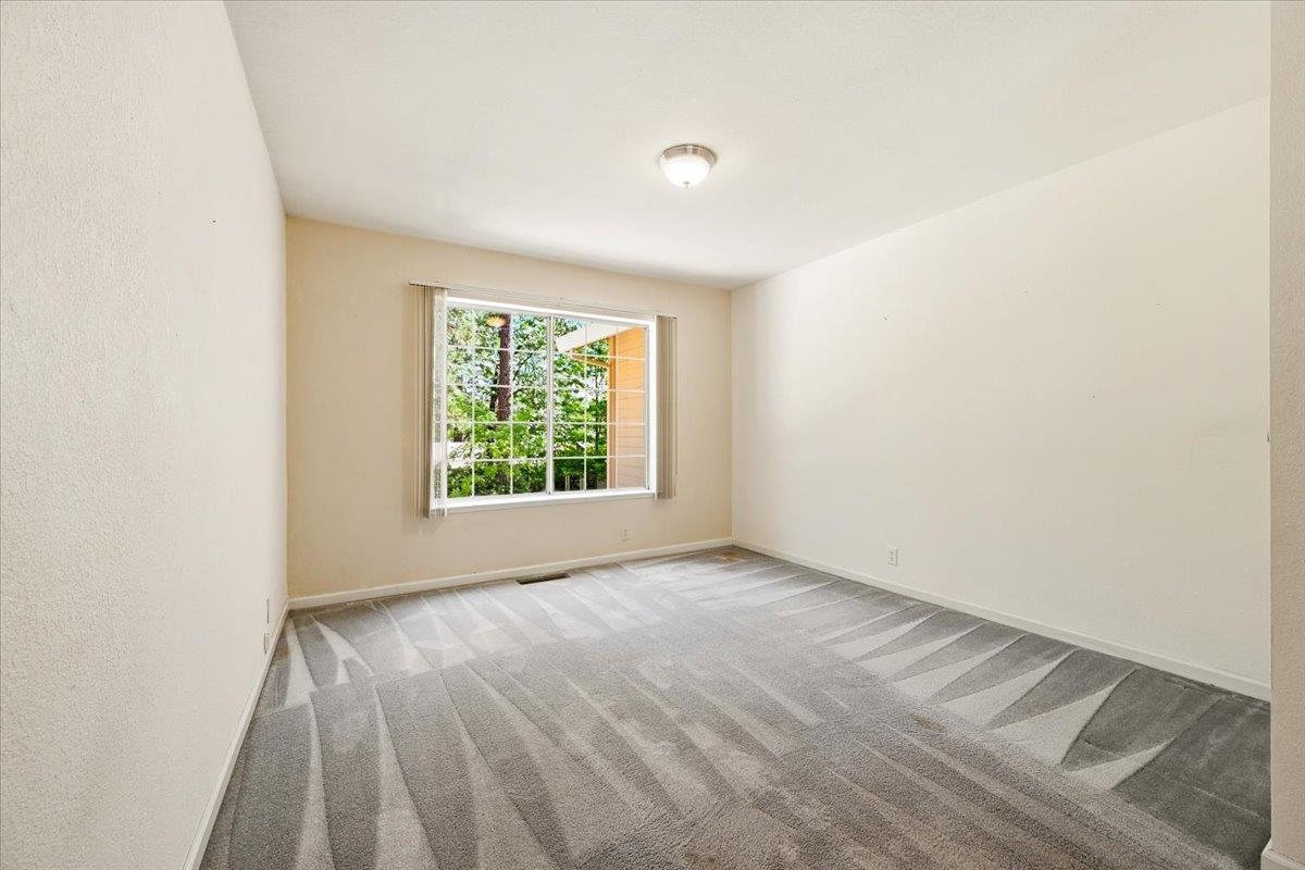 12600 Friar Tuck Road Grass Valley, CA 95949 - Photo 7 of 56 an empty room with wooden floor and windows