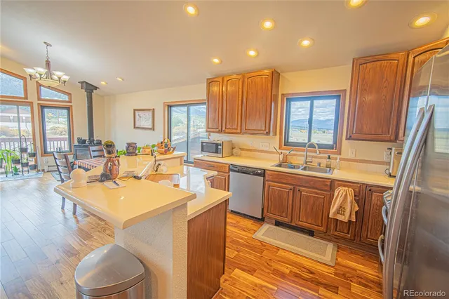 a large kitchen with kitchen island granite countertop a sink and dishwasher with a dining table