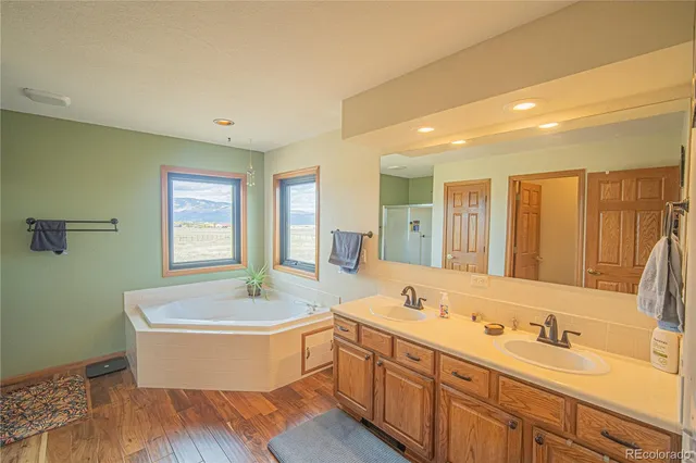 a bathroom with a double vanity sink tub and mirror
