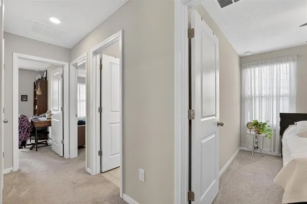 a bedroom with a bed and a potted plant