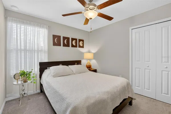 a bed sitting in a bedroom next to a window