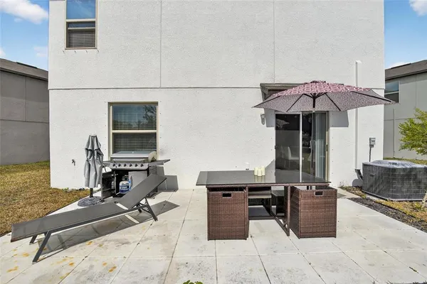 a view of a livingroom with wooden floor and kitchen space