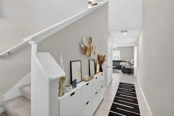 a view of a hallway with furniture and stairs