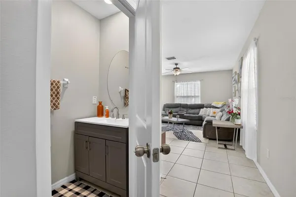 a living room with furniture and kitchen view