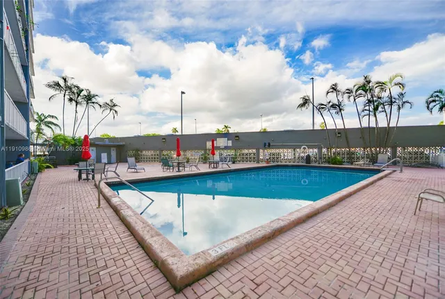 a swimming pool with outdoor seating