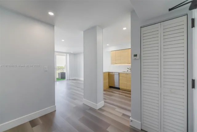 a view of a hallway with wooden floor