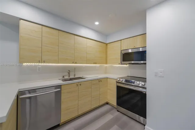 a kitchen with a sink stove and microwave