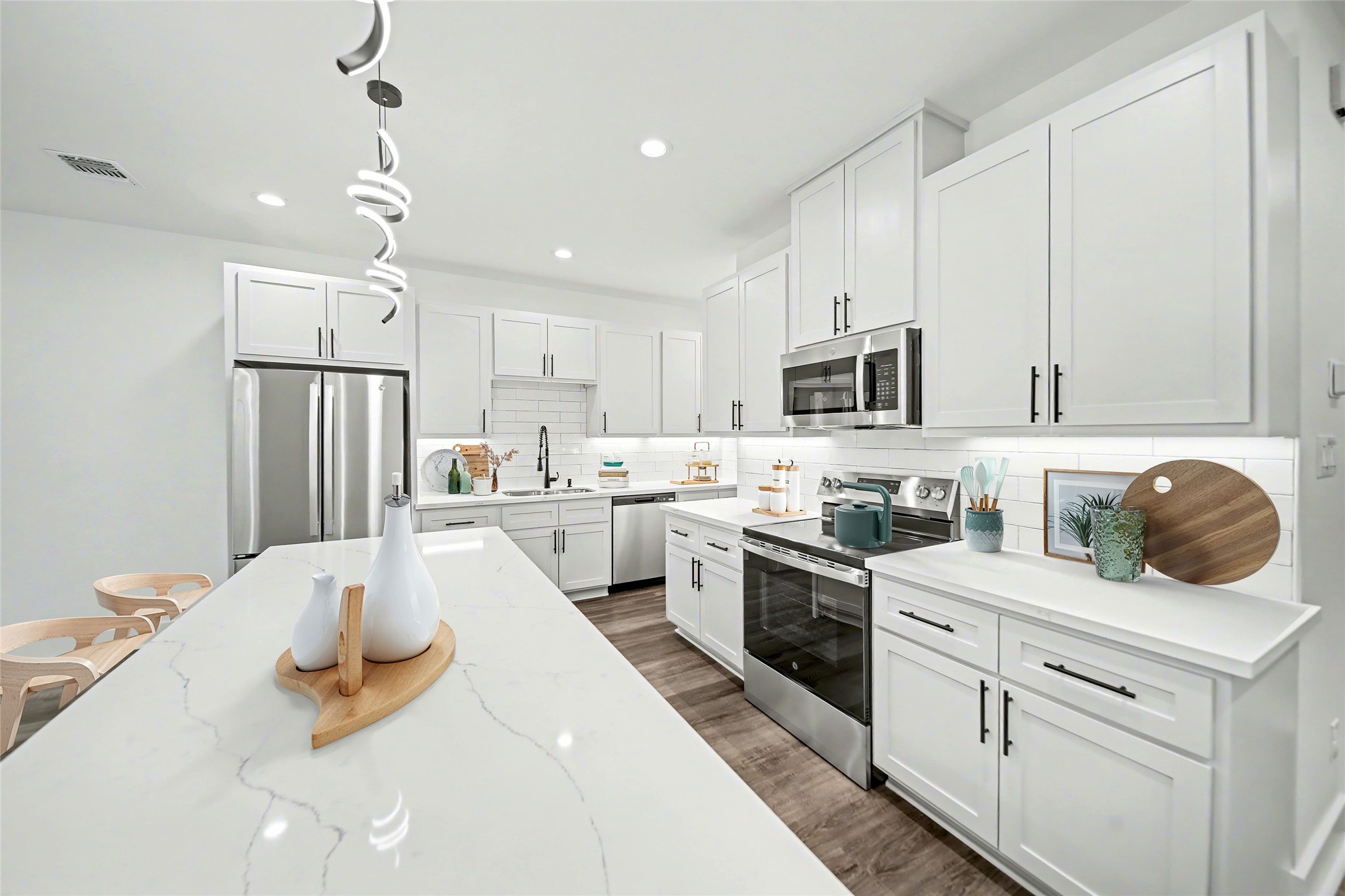 a kitchen with white cabinets and stainless steel appliances