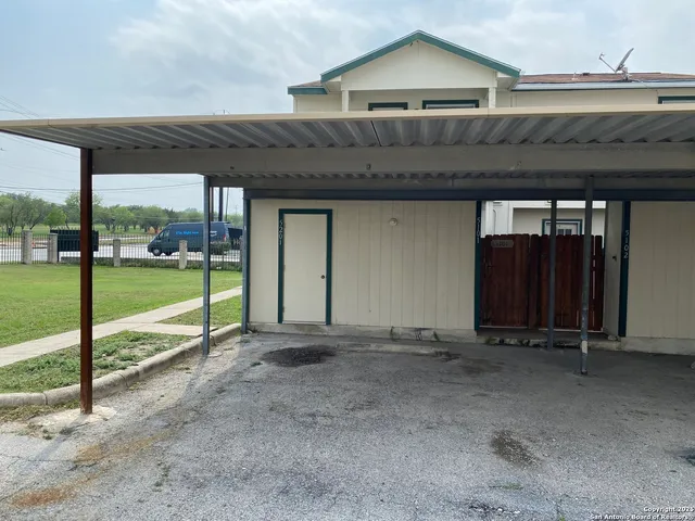 a view of a house with a floor and wooden fence