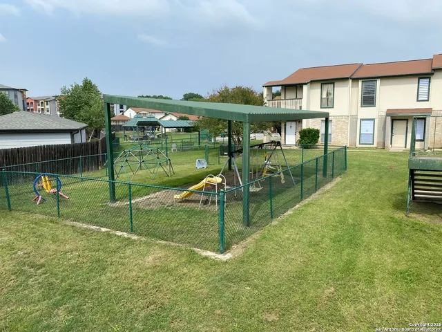 a swimming pool view with a seating space