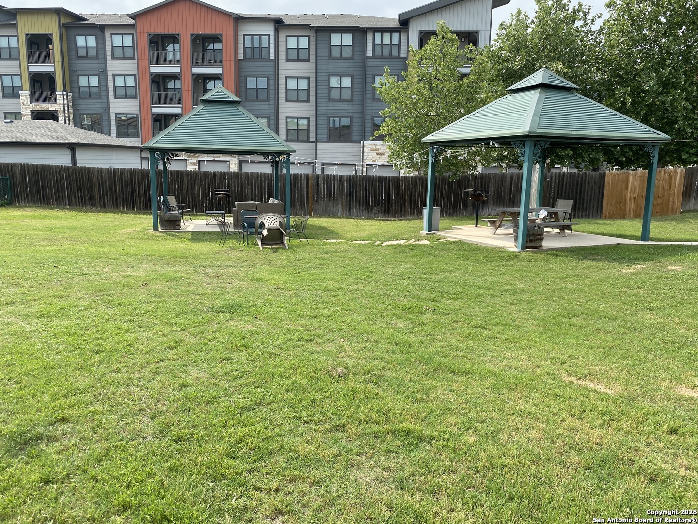 4949 Hamilton Wolfe Road, Unit 5201 San Antonio, TX 78229 - Photo 23 of 29 a swimming pool with table and chairs under an umbrella