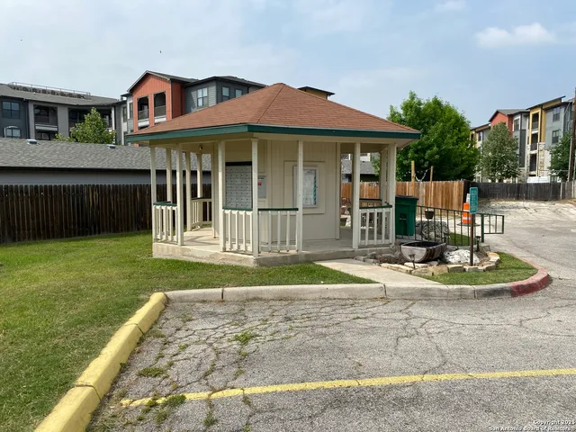 a view of a backyard with swimming pool and sitting area