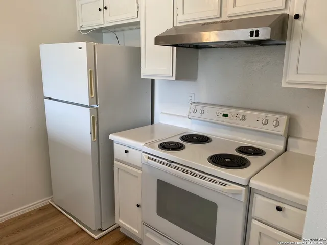 a white refrigerator freezer sitting inside of a kitchen