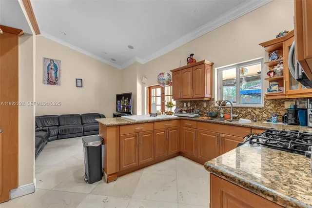 a kitchen with granite countertop a sink and a stove