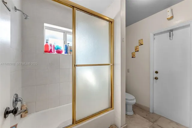 a bathroom with a shower and a toilet