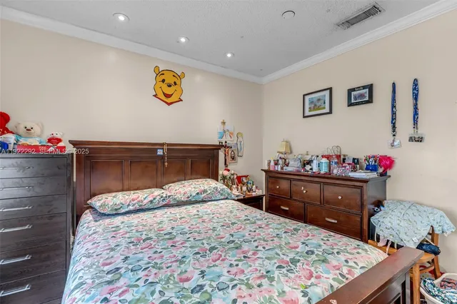 a bedroom with a bed and a dresser in it