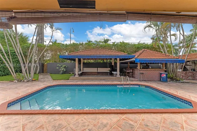 a view of swimming pool with sitting area