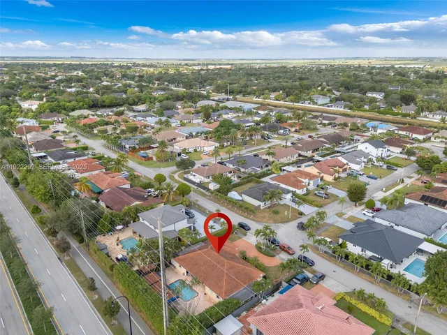 an aerial view of residential houses with outdoor space