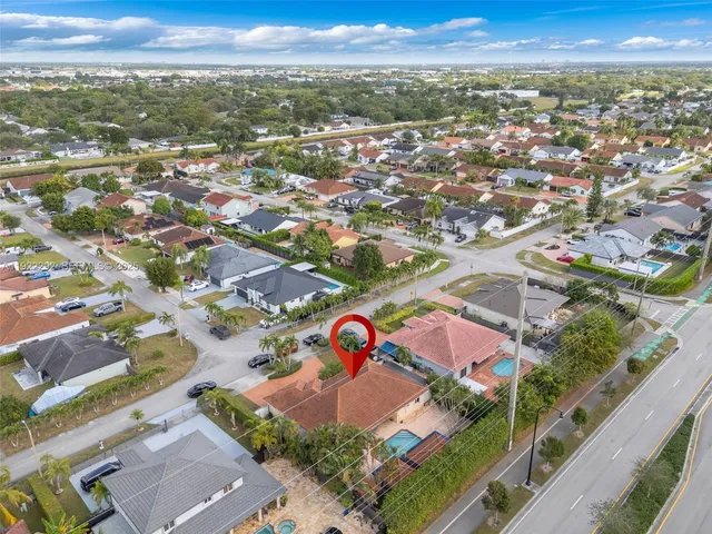 an aerial view of residential houses with outdoor space