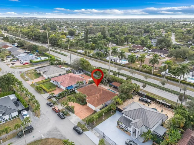an aerial view of a house with a yard and a fountain