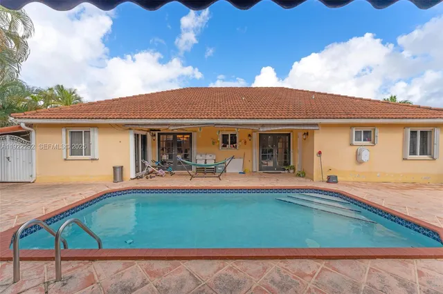 a front view of a house with patio and swimming pool