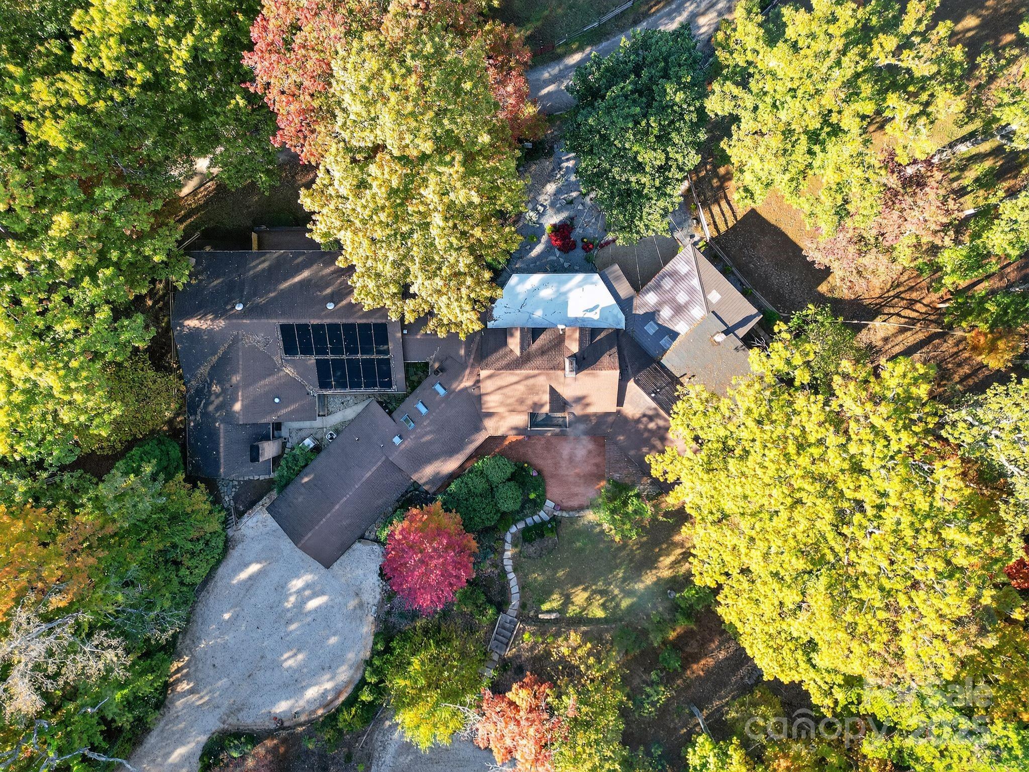 777 South River Road Tryon, NC 28782 - Photo 11 of 42 an aerial view of a house with a yard and garden