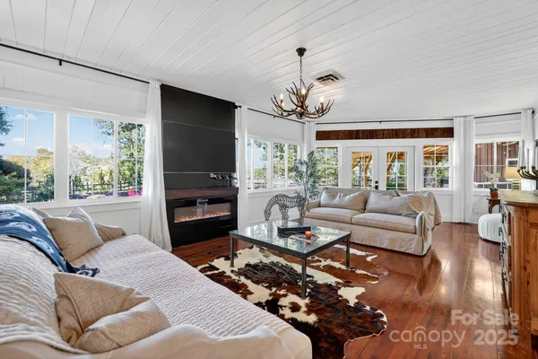 a living room with fireplace furniture and a flat screen tv