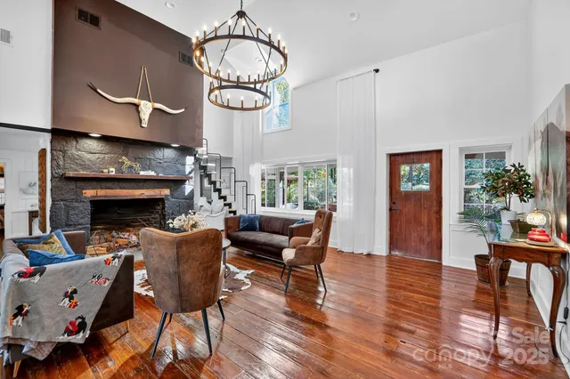 a living room with furniture fireplace and a large window