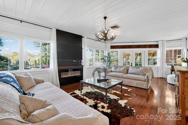 a living room with fireplace furniture and a flat screen tv