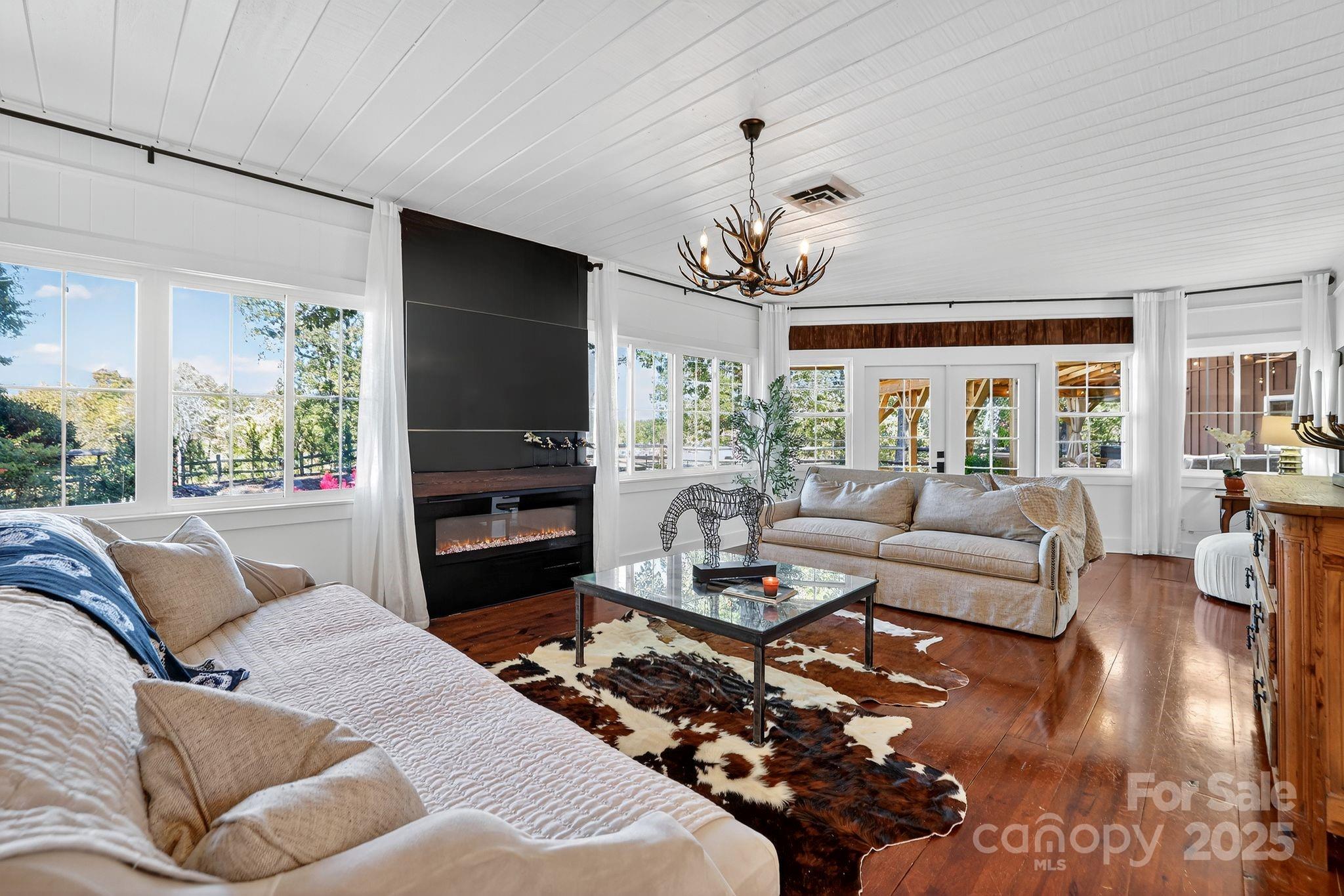 777 South River Road Tryon, NC 28782 - Photo 20 of 42 a living room with furniture fireplace and a large window