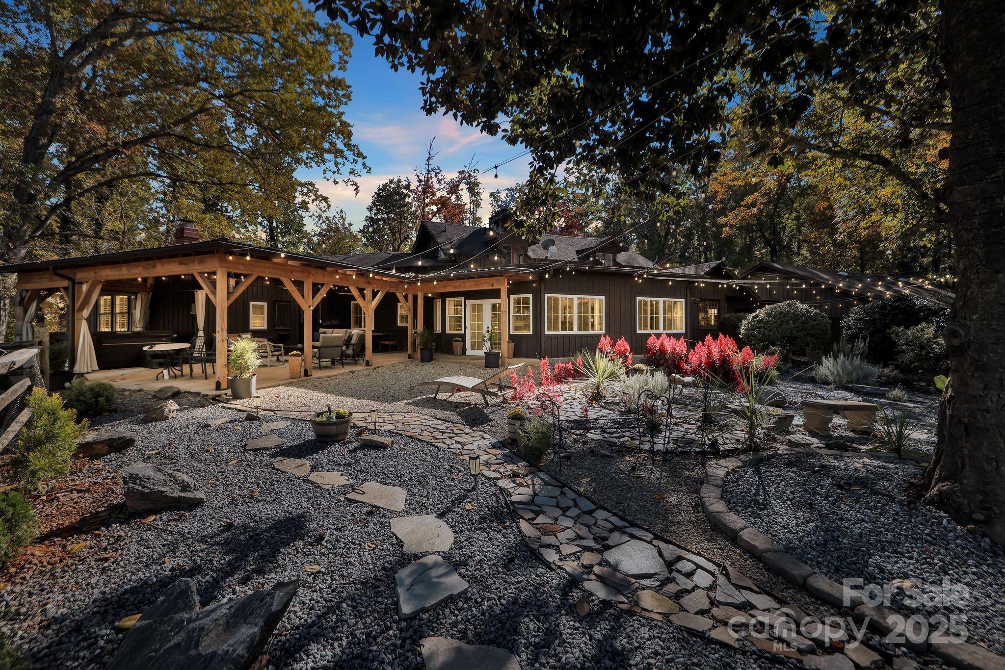 777 South River Road Tryon, NC 28782 - Photo 2 of 42 a front view of a house with garden