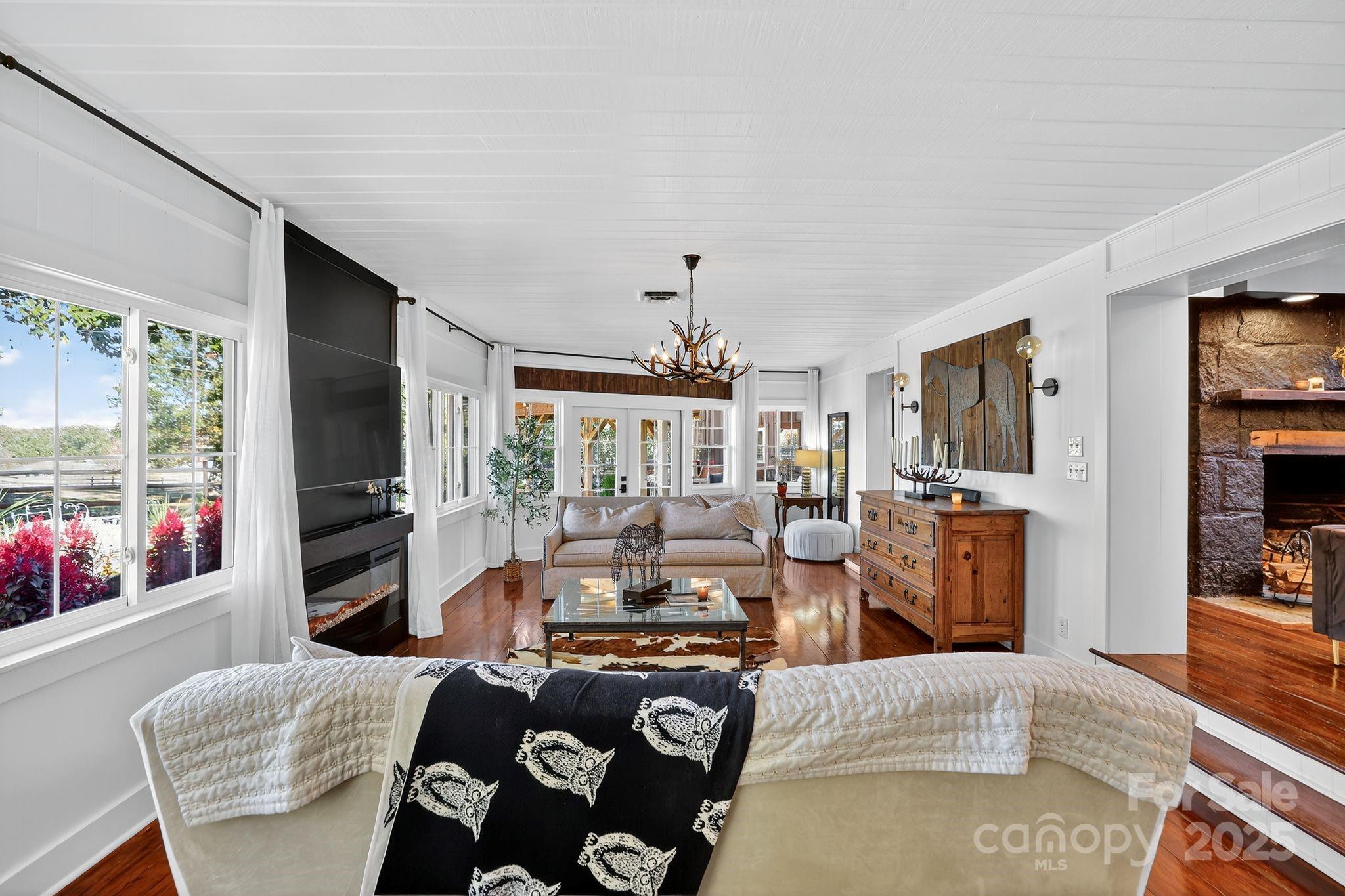 777 South River Road Tryon, NC 28782 - Photo 25 of 47 a living room with furniture fireplace and flat screen tv
