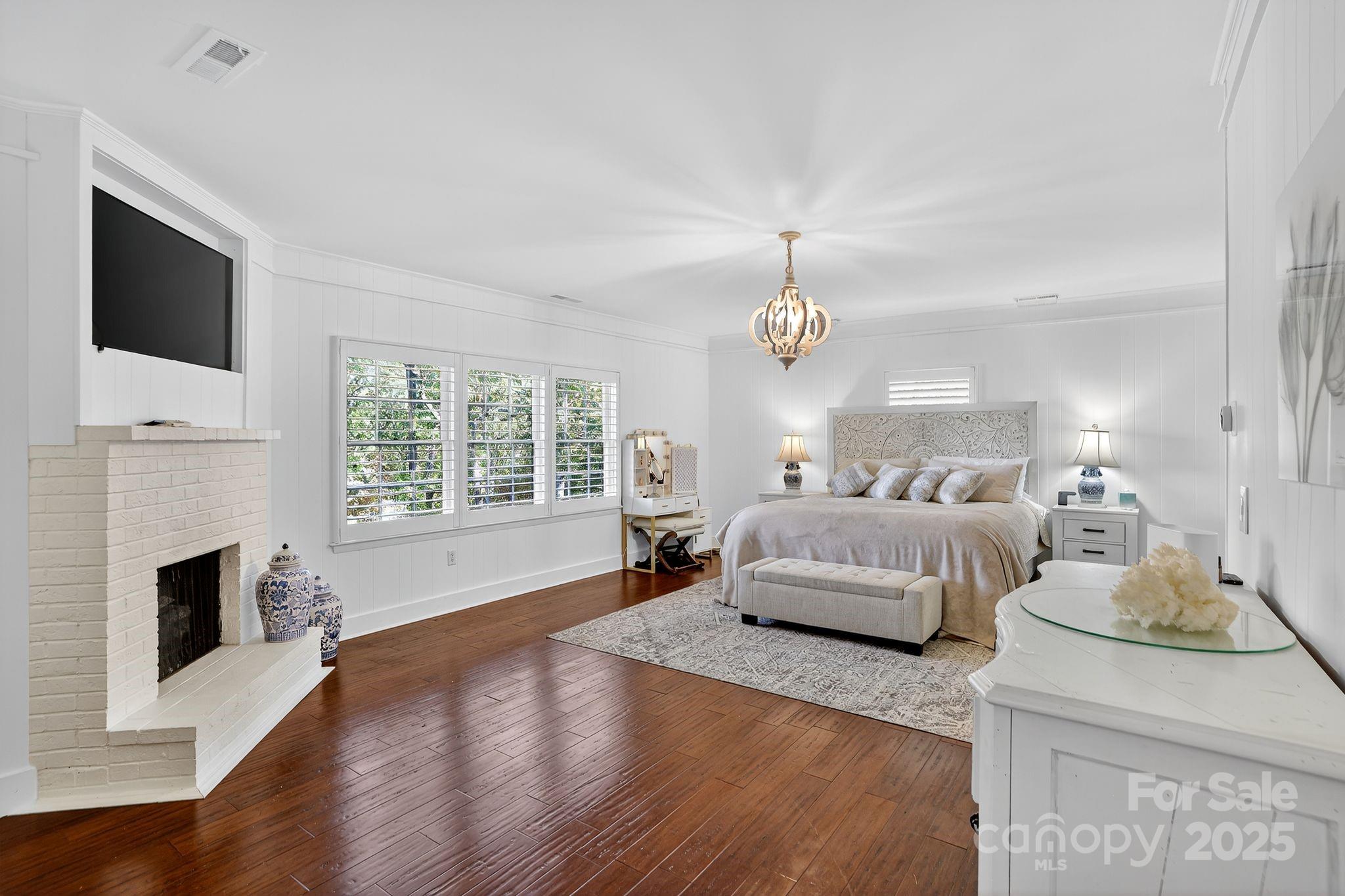 777 South River Road Tryon, NC 28782 - Photo 27 of 42 a spacious bedroom with a bed and a flat screen tv