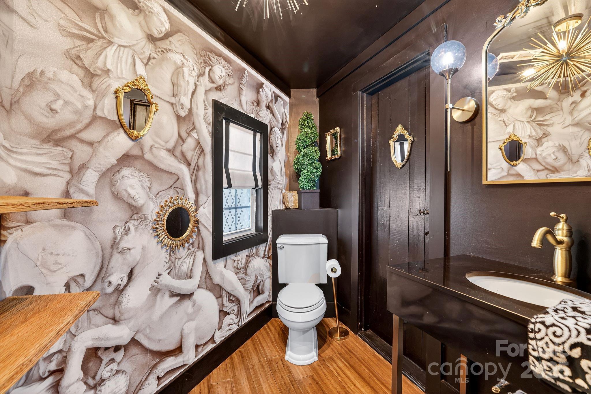 777 South River Road Tryon, NC 28782 - Photo 30 of 42 a bathroom with a toilet sink and mirror